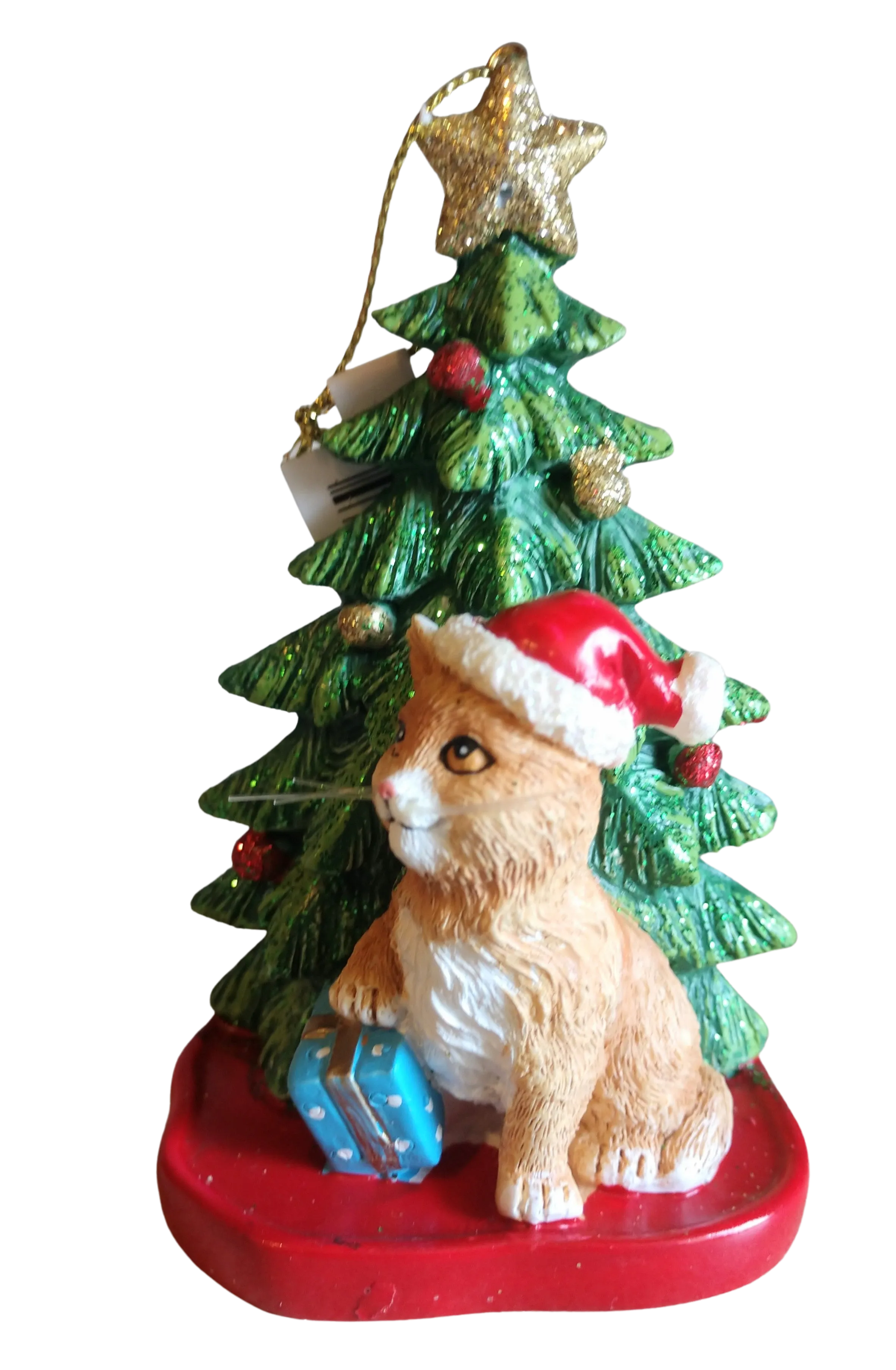 Brown Cat Sitting By Christmas Tree Wearing A Red Santa Hat Ornament